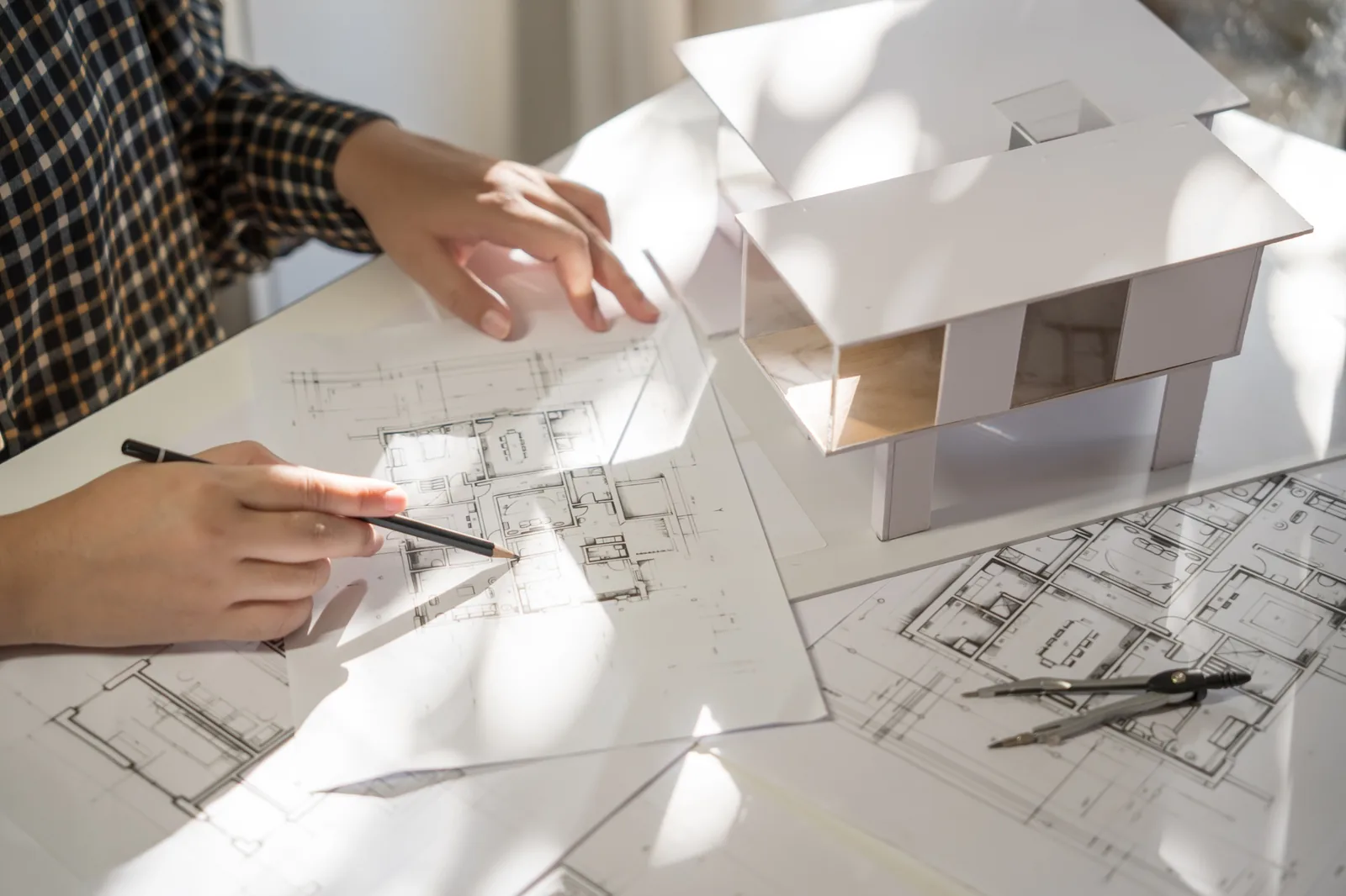 Architect working over architectural drawings of an existing building