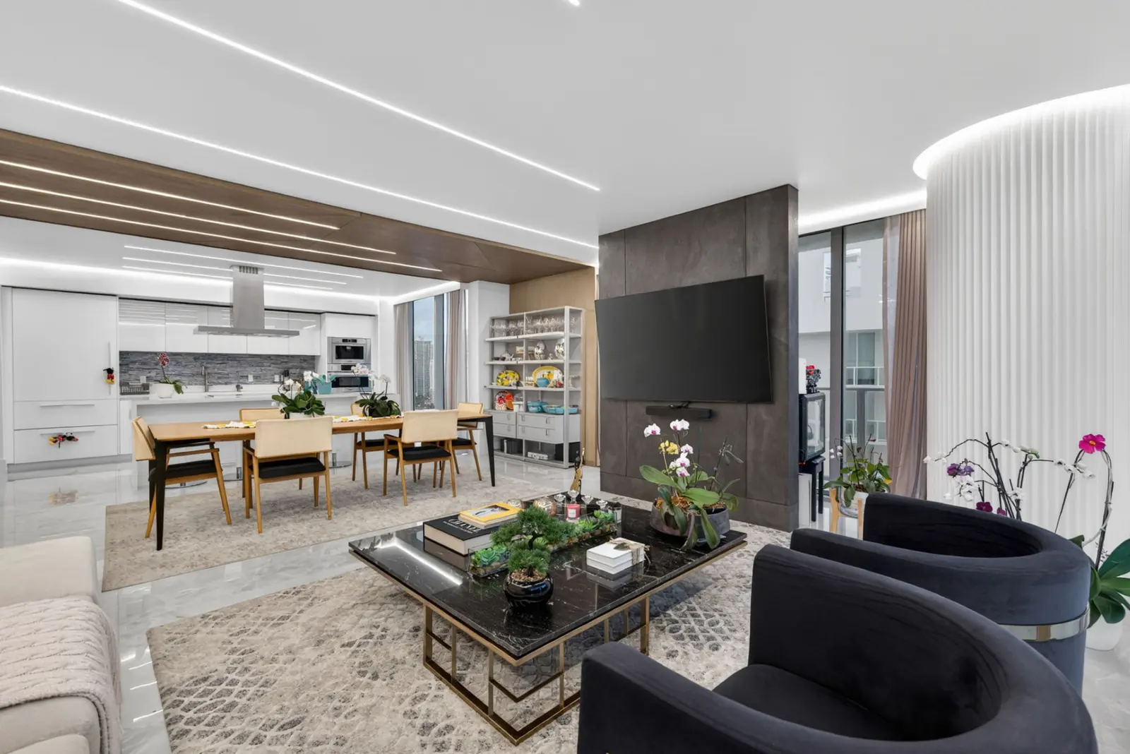 Living room flowing into the dining area and kitchen with wood ceiling accents