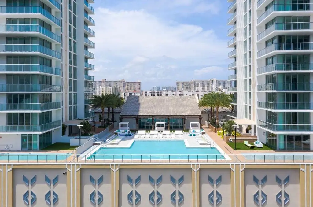 Pool deck between glass towers on a sunny day